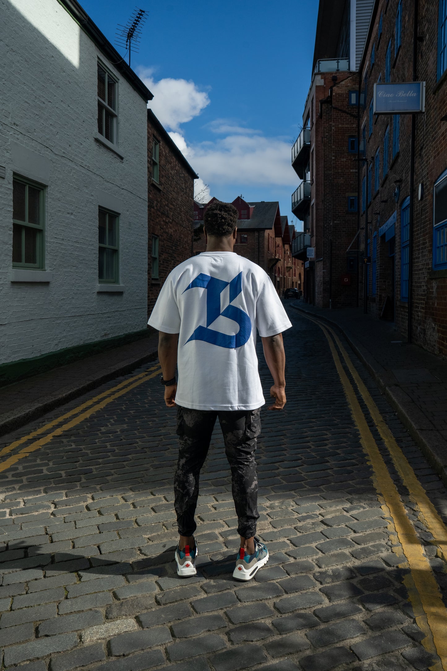 TBB TEE: OVERSIZED BACK LOGO